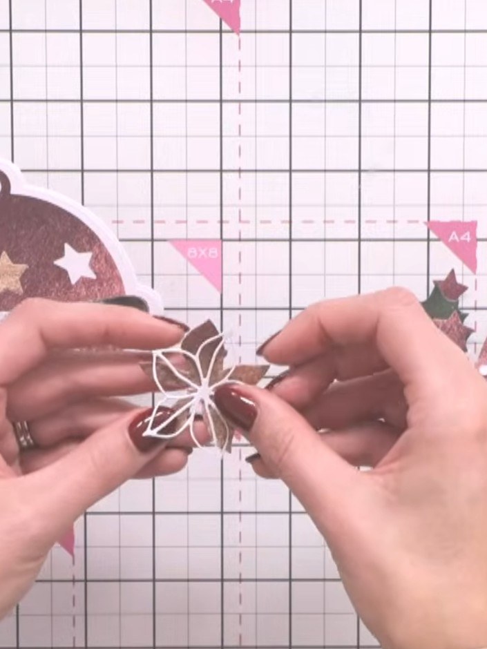 Step 10: Layer and embellish the front cover with cut-out flowers, foliage and berries, offsetting them for visual inte