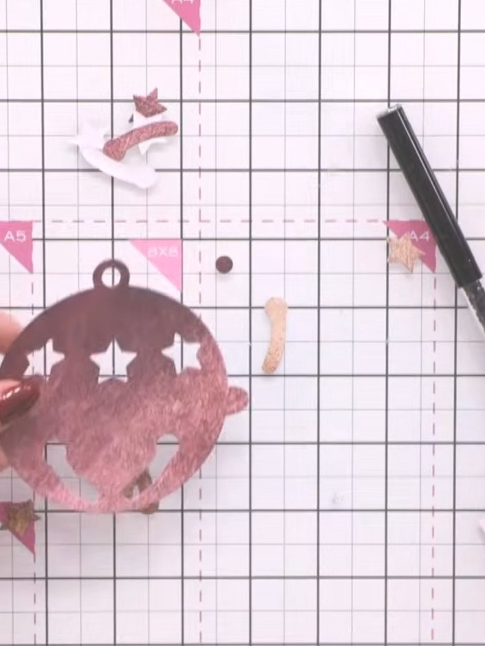 Step 5: Attach the pink glittered bell die-cut to the front of your folded card using double-sided tape to create your