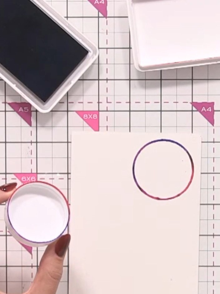 Step 4: Continue creating circular outlines across your watercolour card using the circular lid. Overlap the circles s