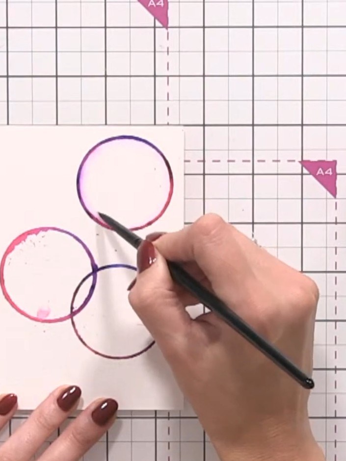 Step 6: Using a clean water brush, add a circle of water inside each coloured circle. This will activate and blend the