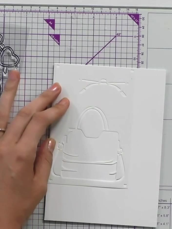 Step 1: Line up the first numbered stencil for the handbag at the edge of your white card blank. Apply black ink throu
