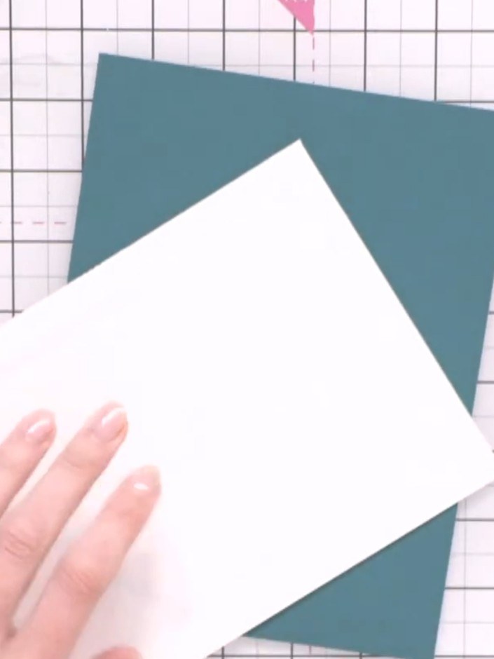 Step 10: Mount the stamped watercolour panel onto the teal card base using foam pads to create dimension.