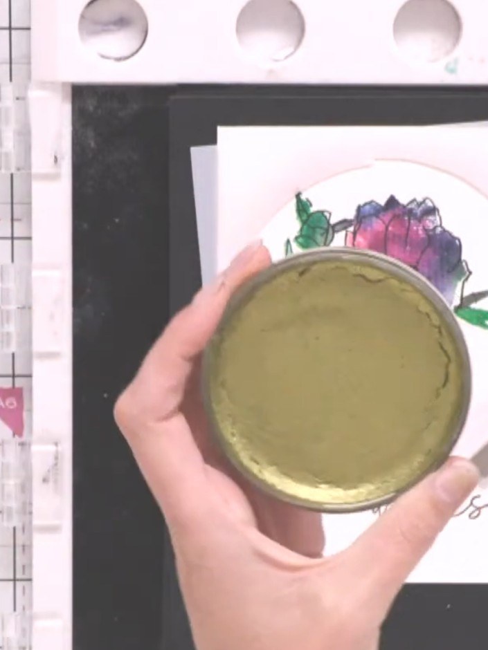 Step 11: Reposition the stencil over the card and apply gold metallic confetti ink with a brush, creating splats within