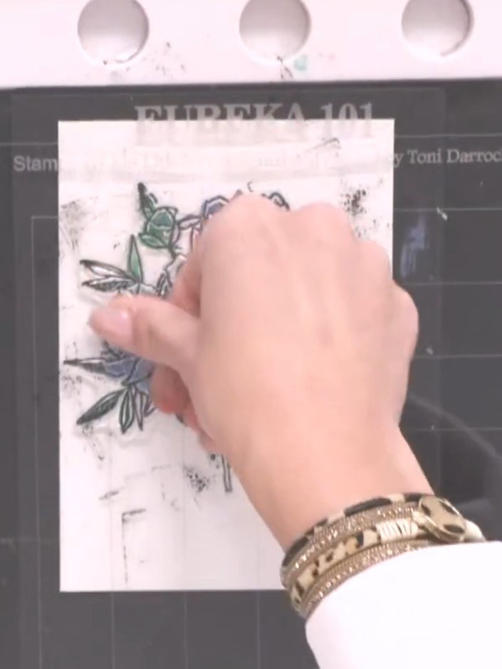 Step 9: Clean the stamp thoroughly. Position the mini stylized circle stencil over the stamped flower design, centring