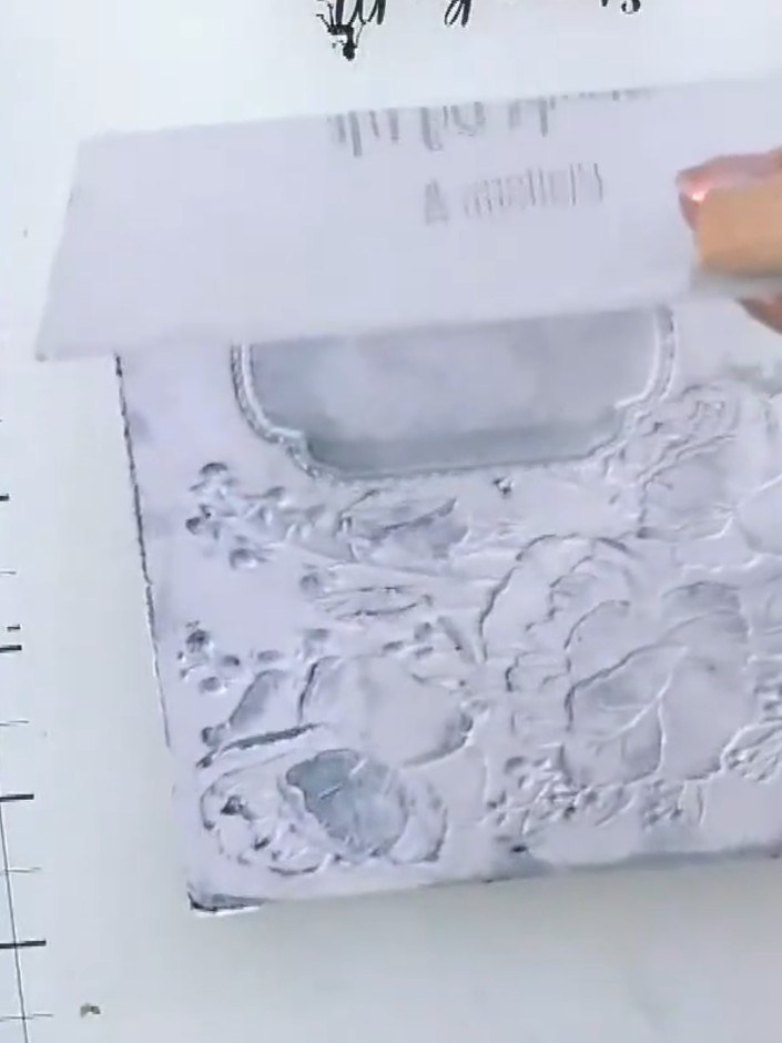 Step 6: If the embossed design appears too light on one side, use a white ink pad to go back over the flowers and rest