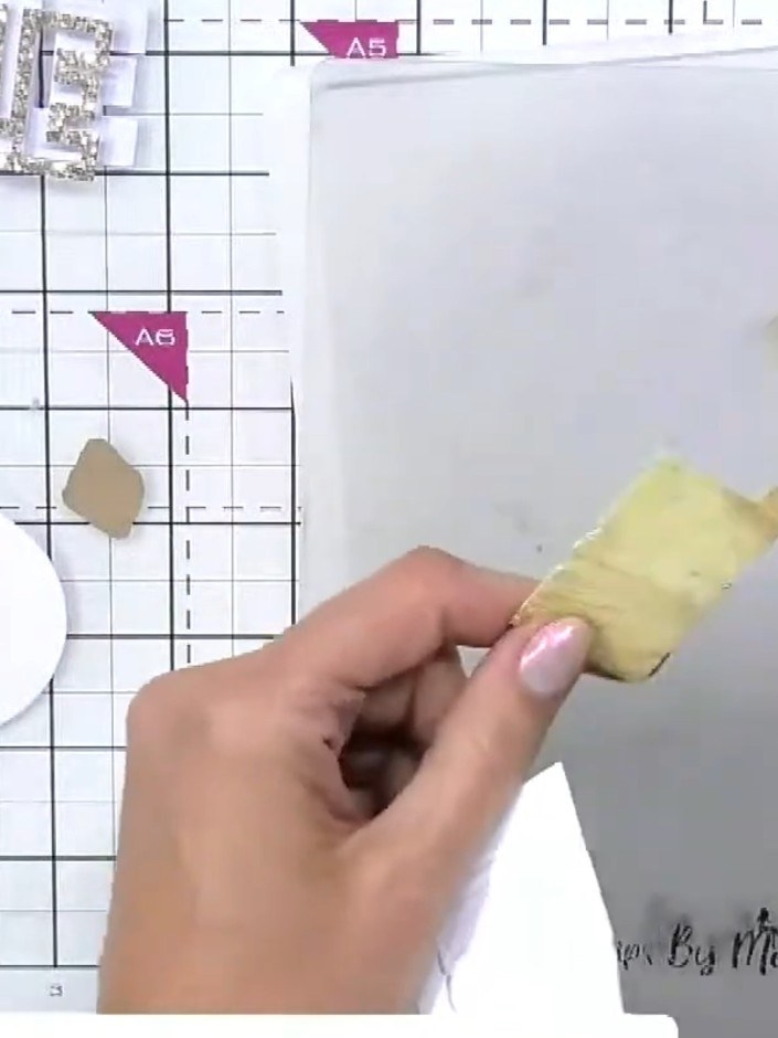 Step 3: Choose one side of the bauble piece and apply a heavier concentration of the gold ink to create shading and de