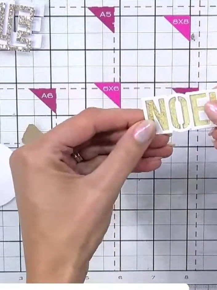 Step 6: Use a piece of card or paper towel to dab and lift some of the wet ink from the 'NOEL' letters for additional 