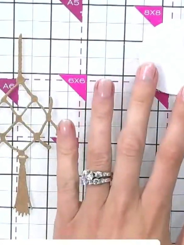 Step 8: Attach the decorative tassel element to the top of the bauble using adhesive. Apply the adhesive to the top of