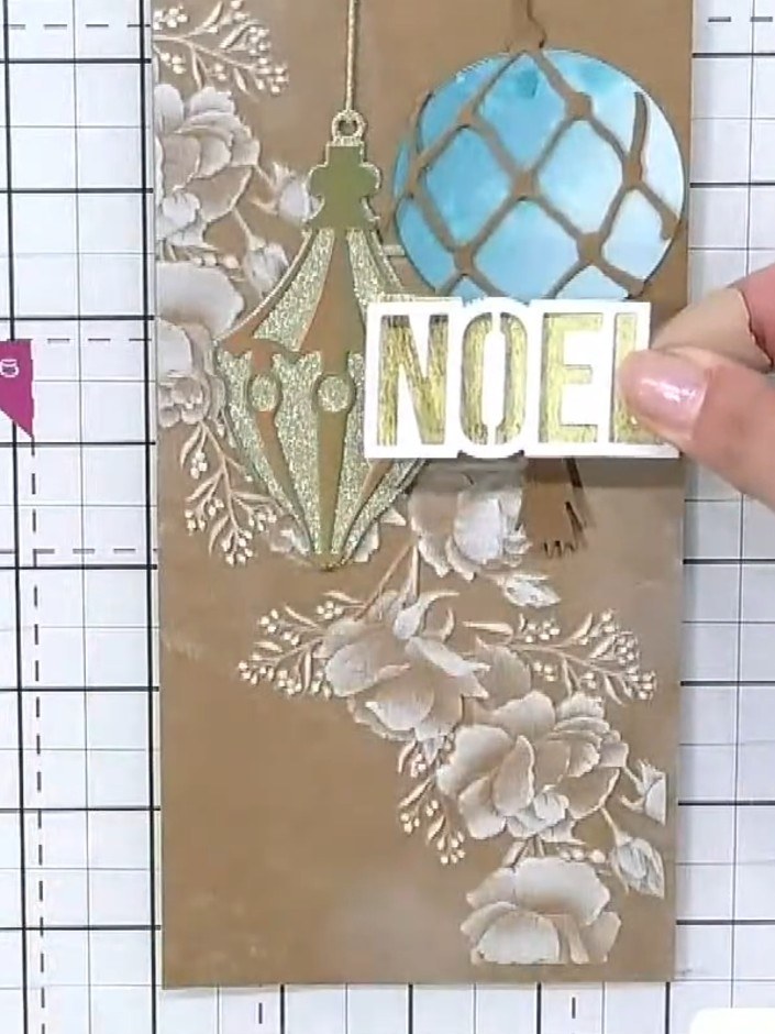 Step 8: Add a sentiment word or greeting from the collection to complete your card. Position the 'NOEL' sentiment on t