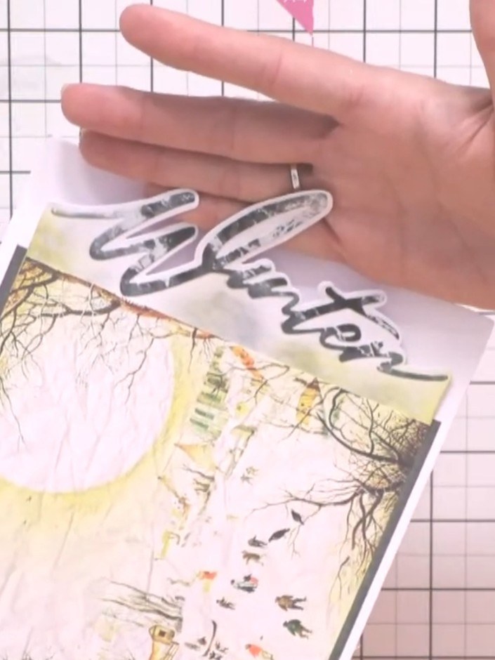 Step 7: Layer the 'Winter' word die-cut over the snow drift edge design to create the snow drift effect across the sen