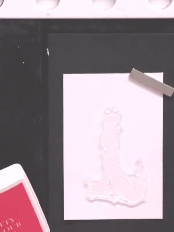 Step 4: Spray the stamped image two or three times with water from a spray bottle to blend and bleed the pink and purp