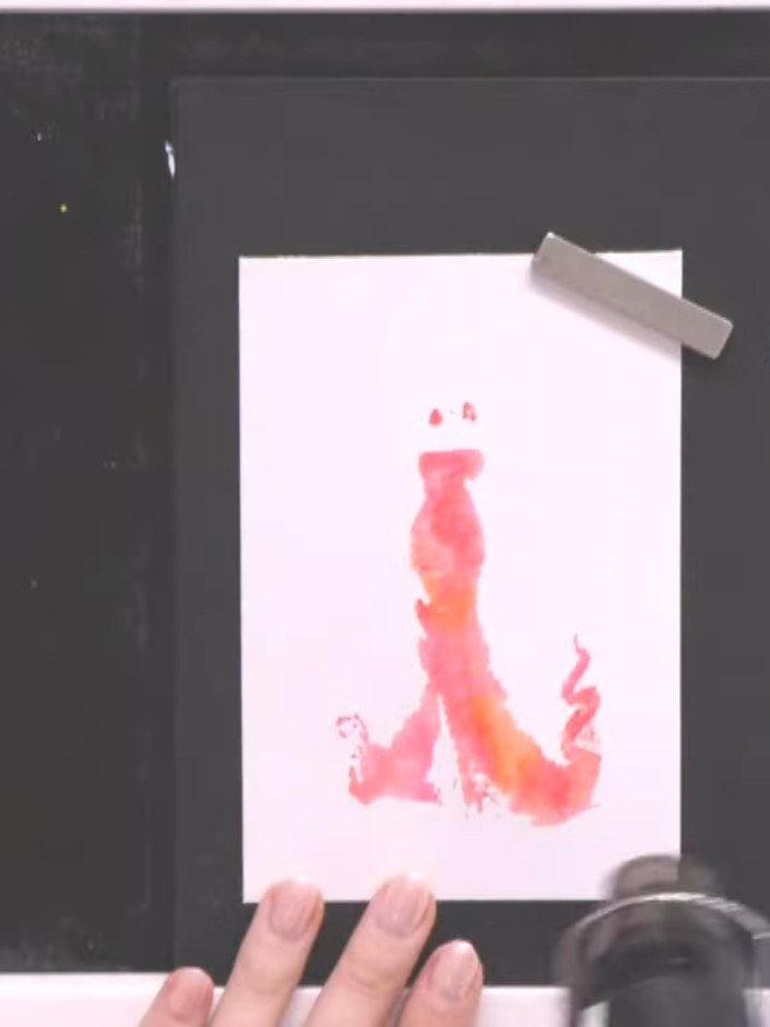 Step 7: Using the packet visual as a reference, position the brayer over the stamped gown image to align where the det