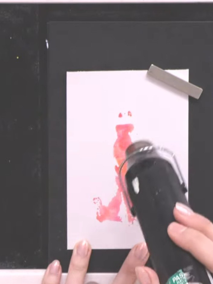 Step 8: Ink the detailed outline stamp in black ink. Carefully position it over the watercoloured gown, aligning it wi