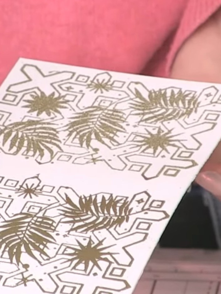 Step 10: Dip the edge of your embossed card into the teal watercolour puddle, allowing the colour to run and blend acro