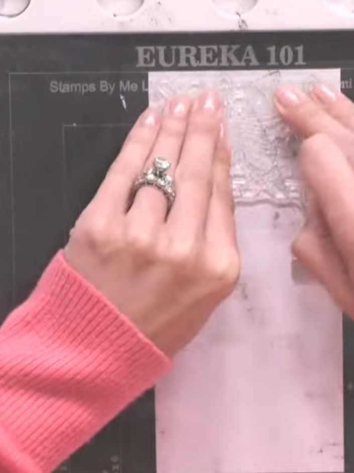 Step 7: Tap off any excess embossing powder from the white card back into the pot to avoid waste and ensure a clean fi
