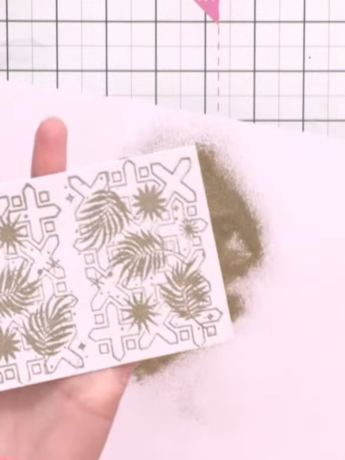 Step 8: Heat set the embossing powder with a heat gun, moving it across the card until the powder melts and becomes sh