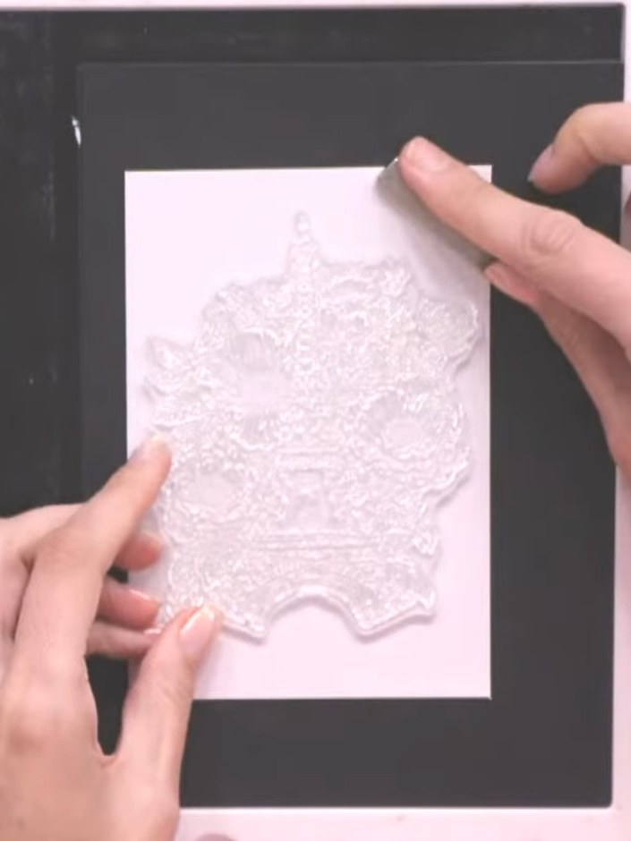 Step 2: Stamp the flower design onto white card stock using the no-line ink pad. Position the stamp carefully and pres
