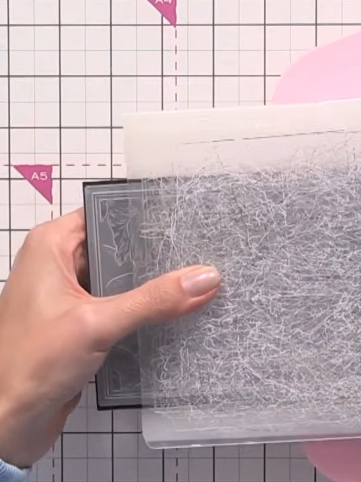 Step 5: Apply white ink pad directly to the embossed surface, swiping across the raised and recessed areas to catch th