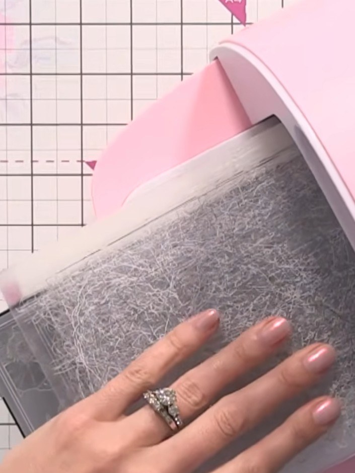 Step 6: Gently tap the white ink pad across the embossed design to ensure full coverage of all the raised detail.