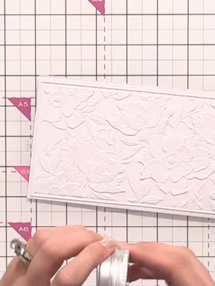 Step 8: Wipe any excess gilding wax from your finger onto a cloth or tissue to avoid waste before applying to your emb