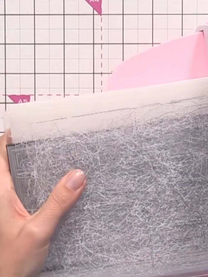 Step 2: Place your embossing folder with the card inside onto the platform of your die-cutting machine. Run it through