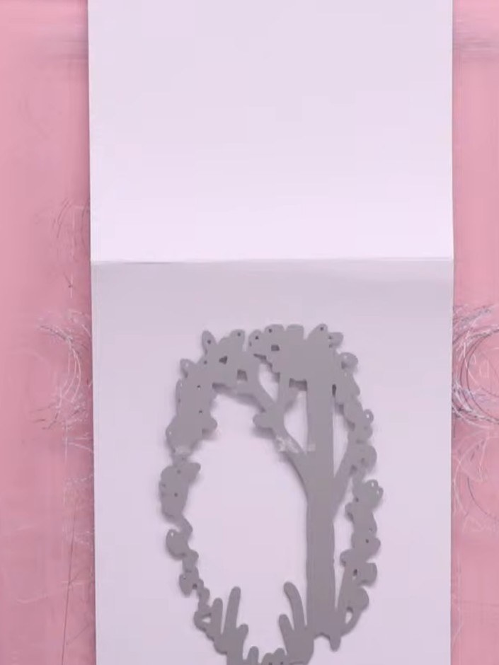Step 1: Cut the aperture die into white card stock using your die cutting machine. This creates a shaped window featur