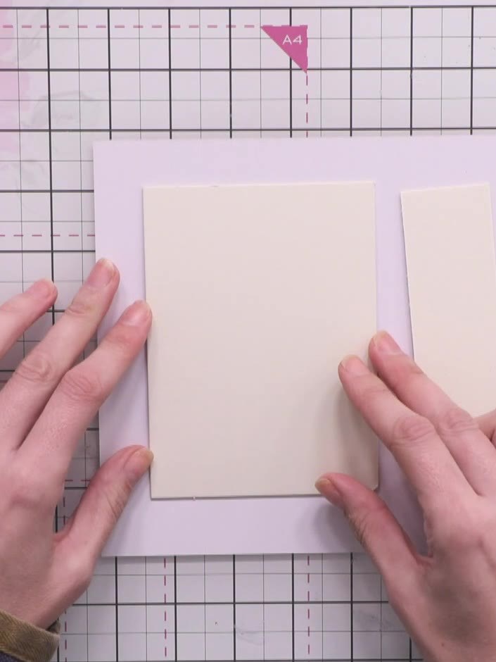 Step 3: Apply fast-grab glue to the mount board piece and carefully attach the first decorative paper, ensuring there 