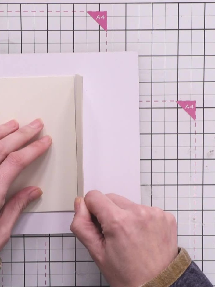 Step 4: Position the spine piece between the front and back covers on your cutting mat, leaving a gap equal to the thi