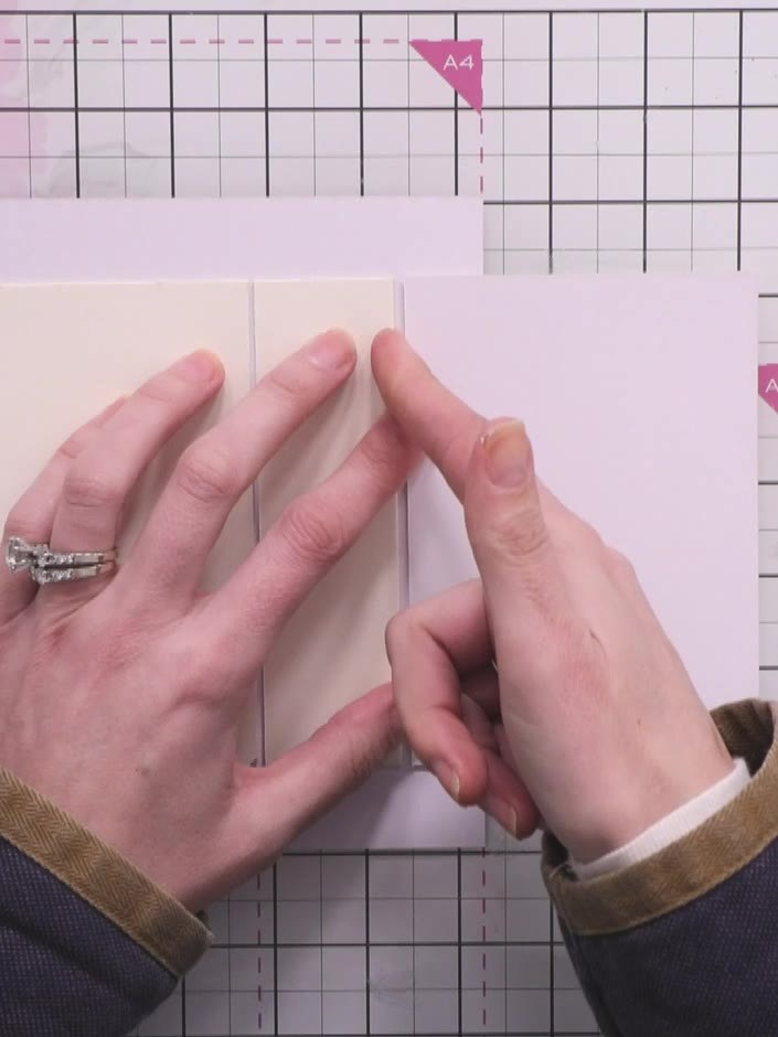 Step 5: Wrap the decorative paper around the spine and covers. Manipulate and warm the paper with your fingers to educ