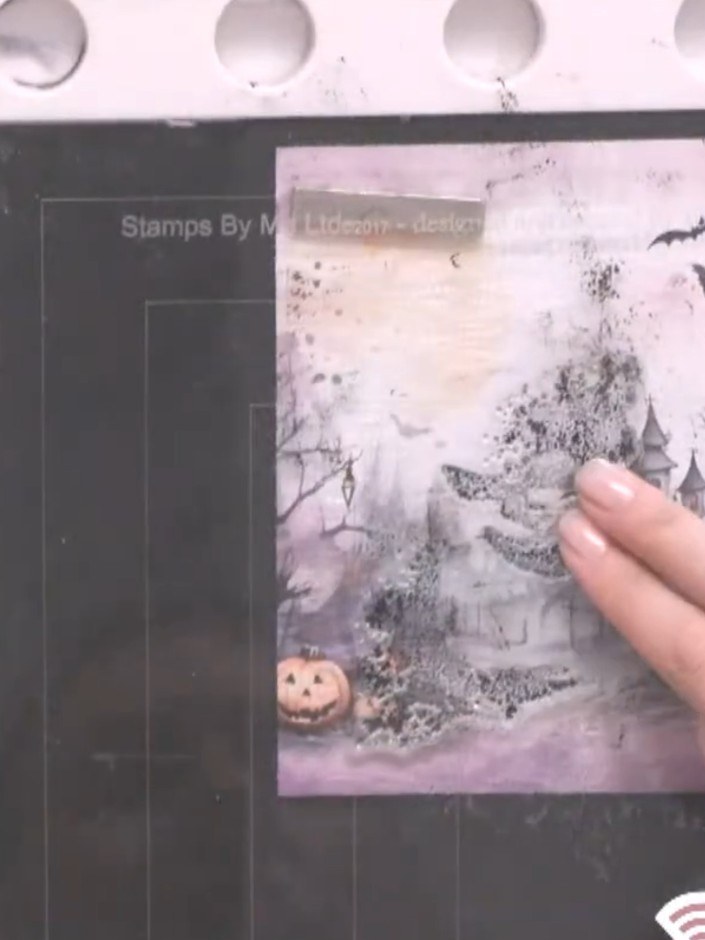 Step 3: Spray the inked stamp three times with water to create a watercolour effect.