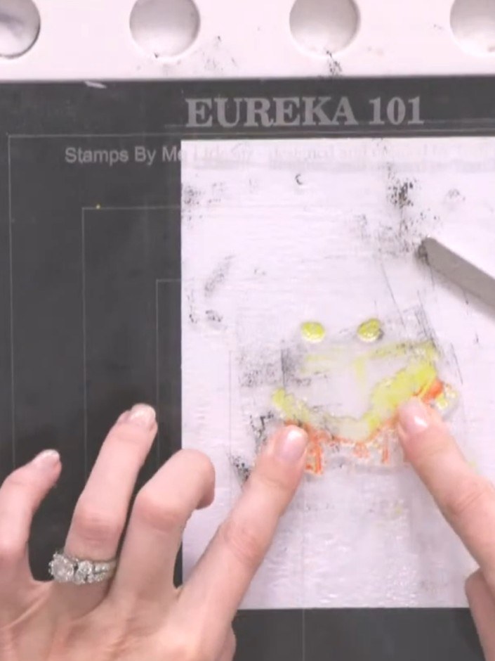 Step 3: Spray the inked stamp with water three times to create a watercolour effect.