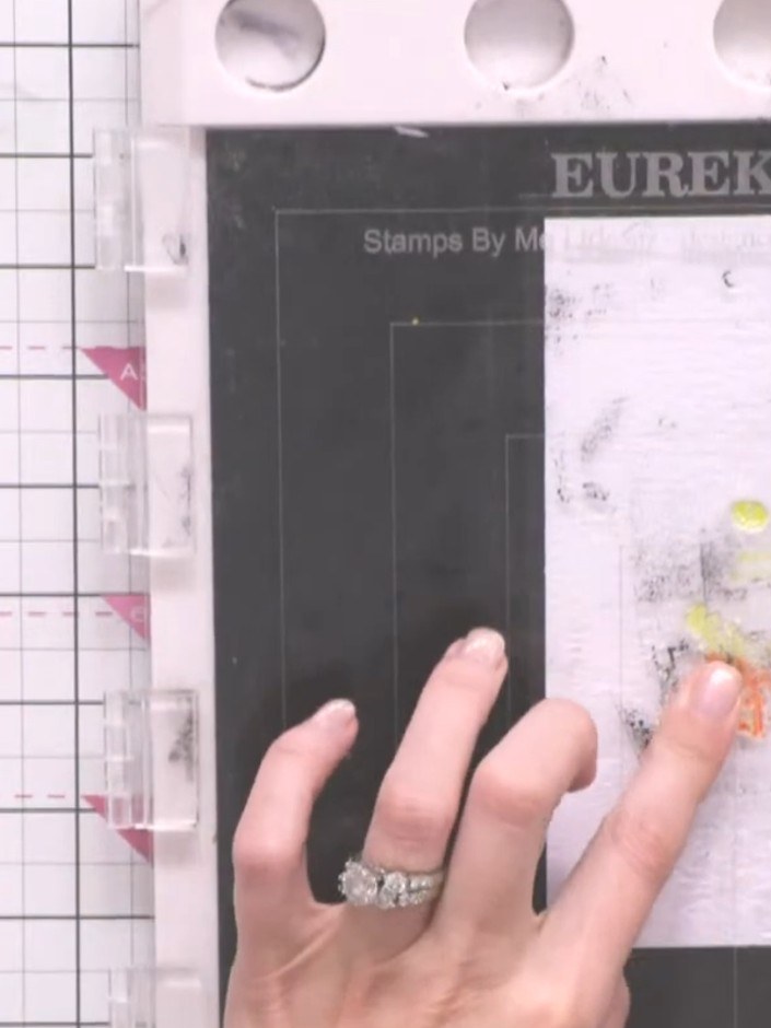 Step 4: Stamp the coloured layer onto your white card using the stamp positioner. Press down firmly to transfer the ye