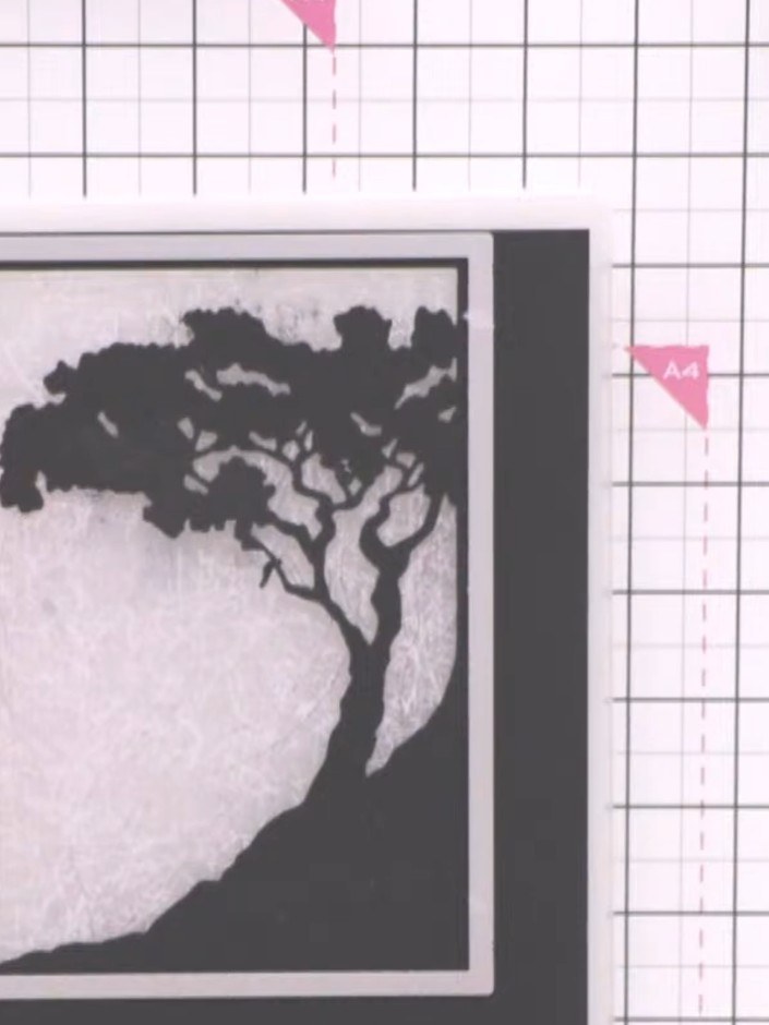 Step 4: Select a patterned paper from the We Can Dream pad that complements your tree silhouette. Position it behind t
