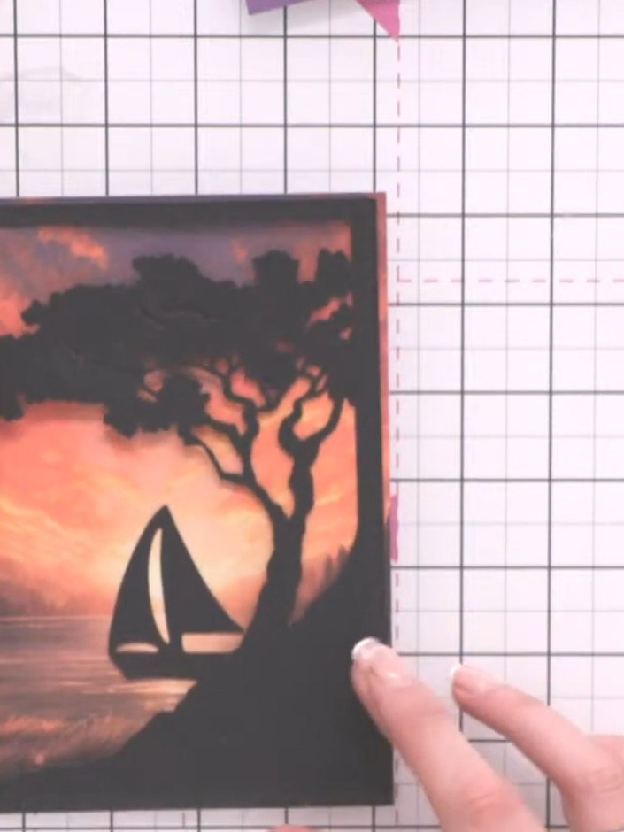 Step 6: Layer the decorative black frame on top of the sunset scene panel, positioning it to create a window effect ar