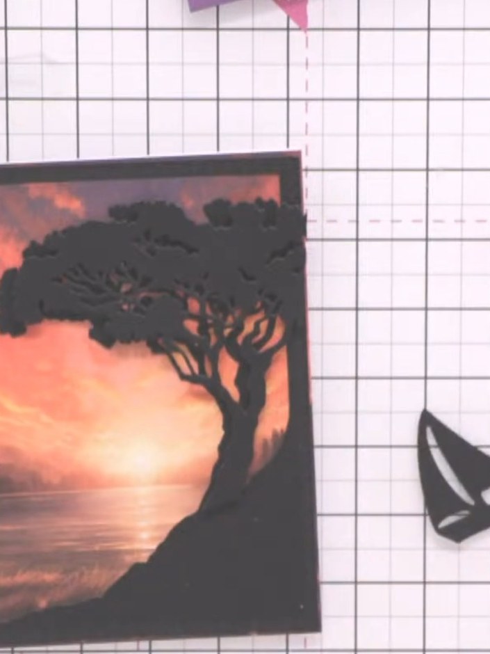 Step 9: Position the 3D tree element slightly offset on top of the framed sunset panel to create a layered, dimensiona