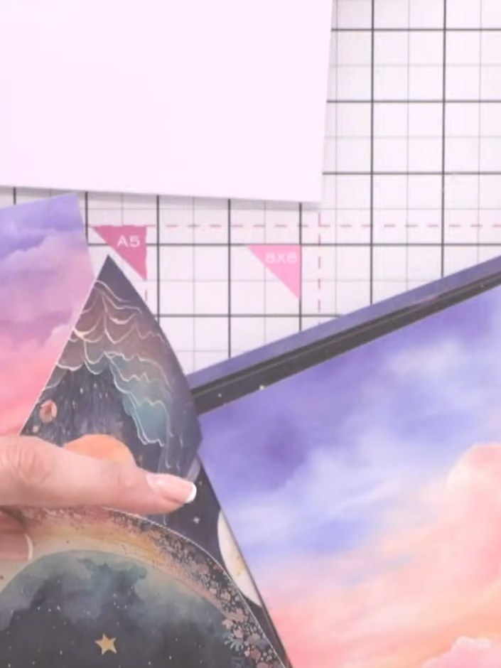 Step 2: Carefully fussy-cut around the moon shape from the printed paper using scissors, following the outline of the 
