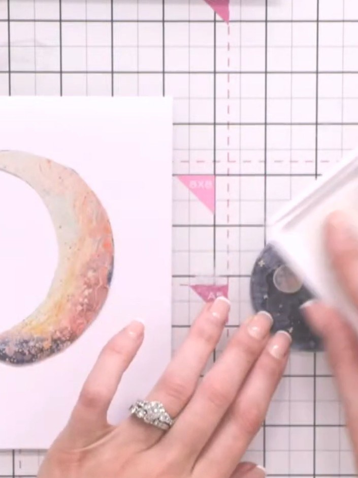 Step 6: Apply white pigment ink to the embossed moon using an ink pad to highlight the embossed detail.