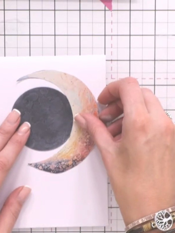 Step 7: Arrange the fussy-cut elements on your card base. Position the moon first, then add the birds and clouds, buil