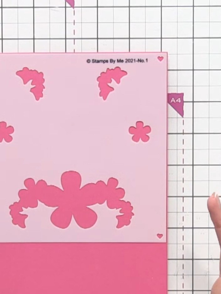 Step 2: Position the first layering stencil (marked number 1) onto your pink card base, aligning it carefully using th