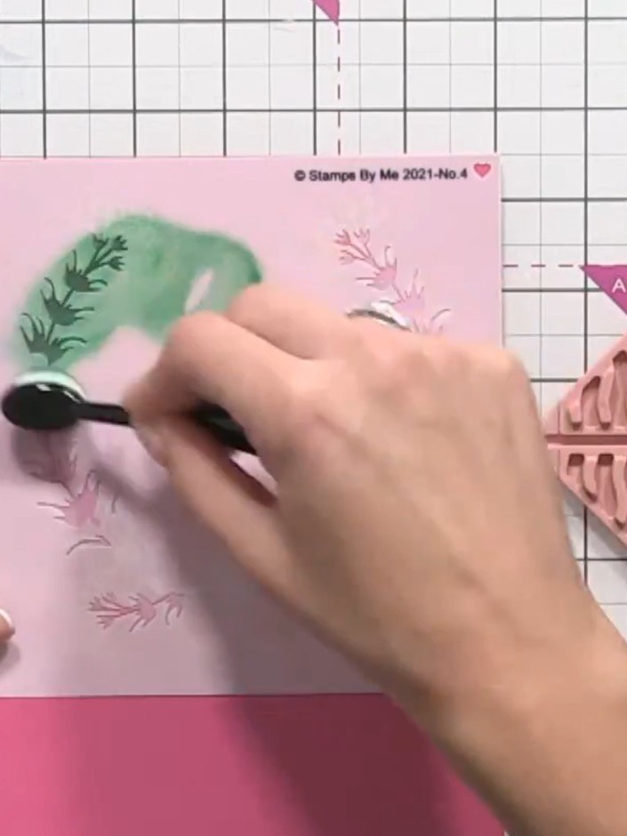 Step 8: Position the fifth stencil over the card and apply green ink through it using a blending tool to add foliage d
