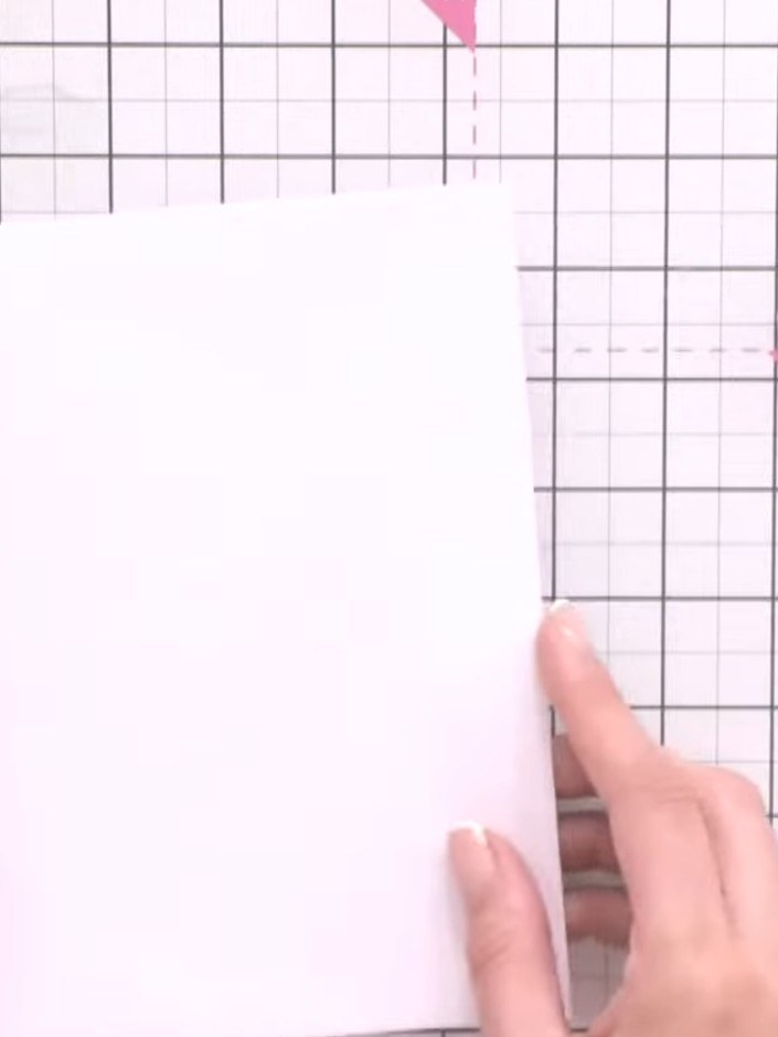 Step 2: Lay out your papers on the craft mat to establish your page background. Position the pale pink cardstock as yo