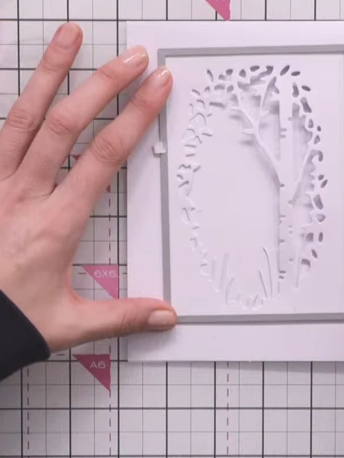 Step 1: Die cut the aperture frame from white card stock using the tree silhouette die. This creates a shaped window w