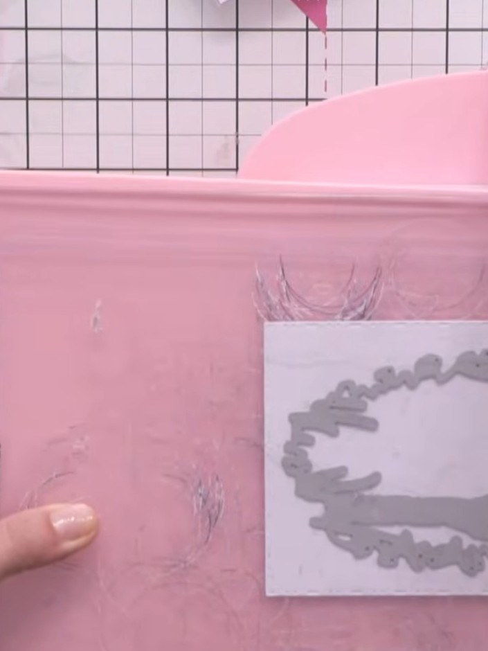 Step 2: Select a piece of patterned paper with a woodland or house design. Position it behind the aperture opening of 