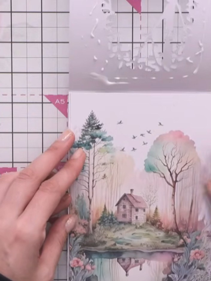 Step 7: Glue the fussy-cut rabbit and flowers in place on the card, layering them to create depth within the woodland 