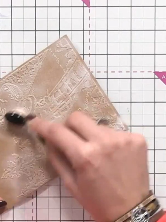 Step 4: Using a dauber or sponge, add white paint splats across the top portion of the embossed card to create a snowy