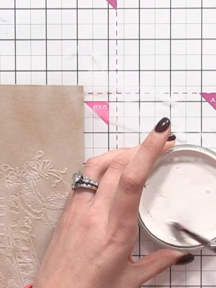 Step 6: Using a white ink pad, pounce over the embossed design to highlight the raised areas. This will bring the Sant
