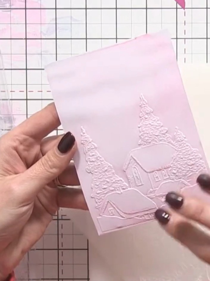 Step 10: Add a sentiment to complete your winter village card. Position the sentiment on the embossed pink panel to fin