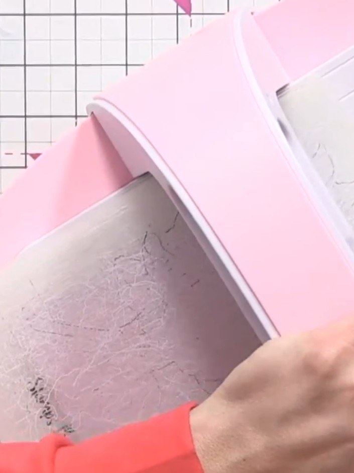 Step 7: Mount the embossed pink card onto black card stock to frame the design. Position the embossed panel centrally 