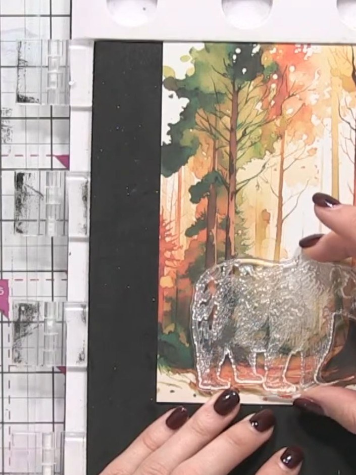 Step 1: Stamp the bear image onto patterned Christmas paper using a brown ink pad. Position the bear towards the botto
