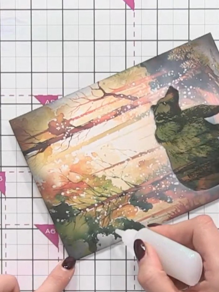 Step 11: Mount the finished bear and forest artwork onto a white or black card blank using adhesive to complete your Ch